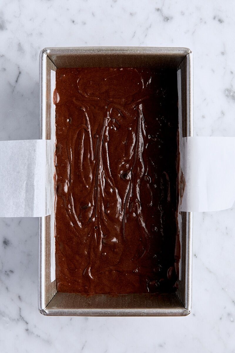 Triple chocolate loaf cake batter in parchment-lined loaf pan