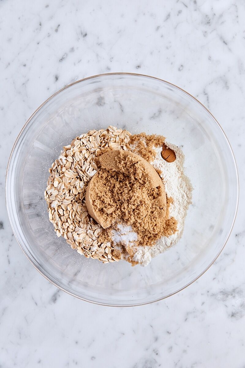 Rolled oats, all-purpose flour, brown sugar, cinnamon, and salt in glass bowl