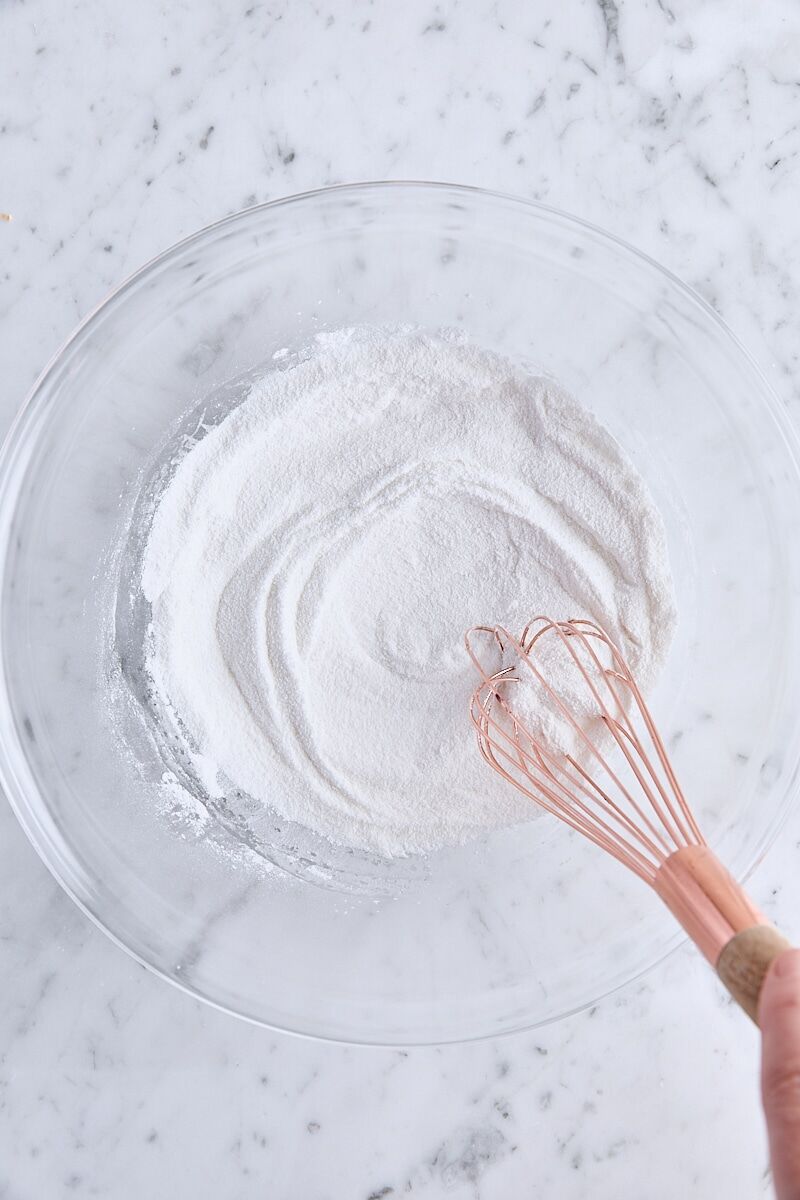 Granulated sugar, arrowroot starch, and salt whisked together in glass bowl