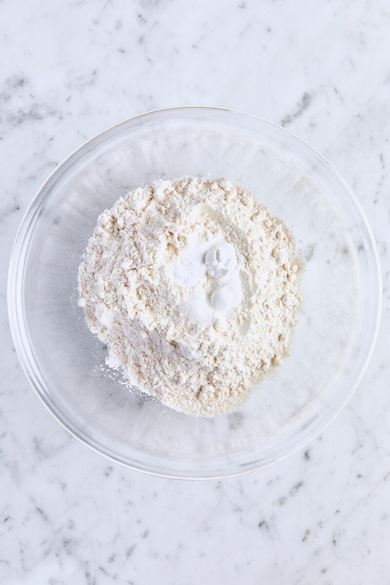 All-purpose flour, baking powder, baking soda, and salt in glass bowl