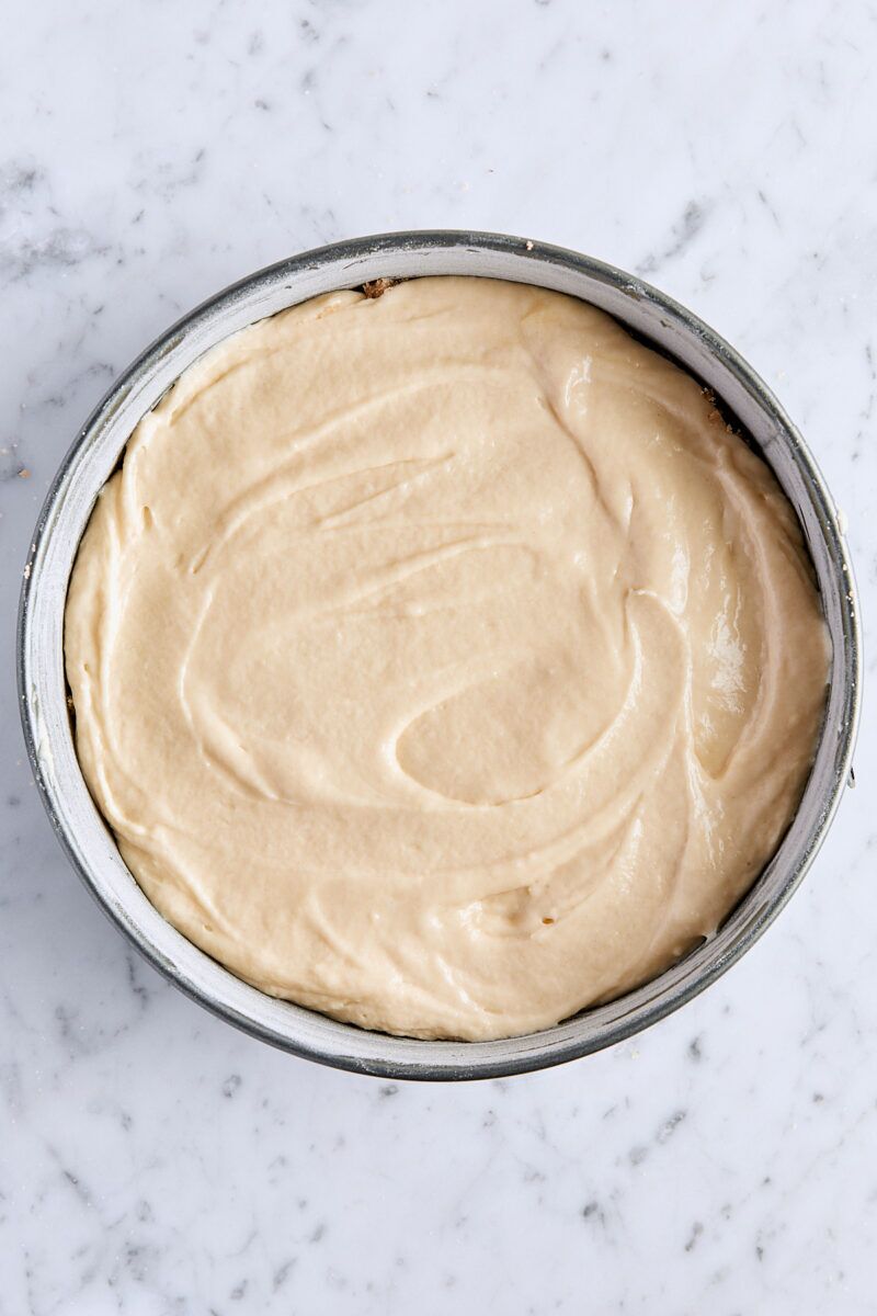 Coffee cake batter layered with streusel in springform pan