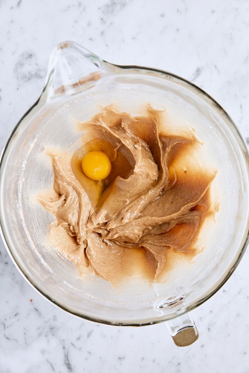 Egg added to batter in glass mixing bowl
