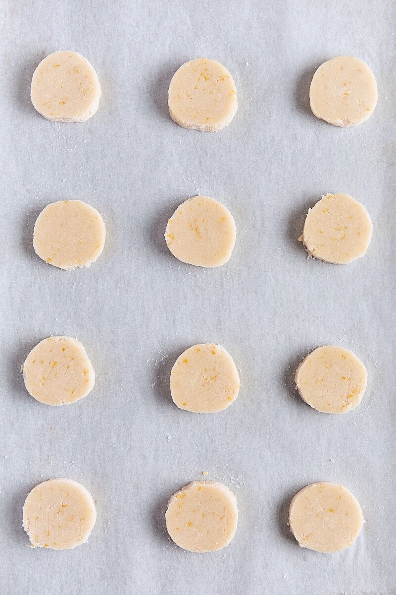 Unbaked shortbread rounds on parchment-lined baking sheet