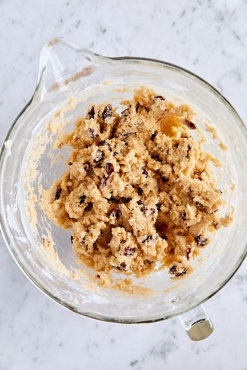 Mixed cranberry orange snickerdoodle dough in glass mixing bowl