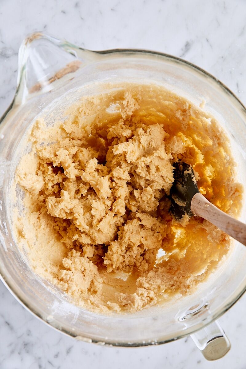 Brown butter sugar cookie dough in glass bowl with spatula