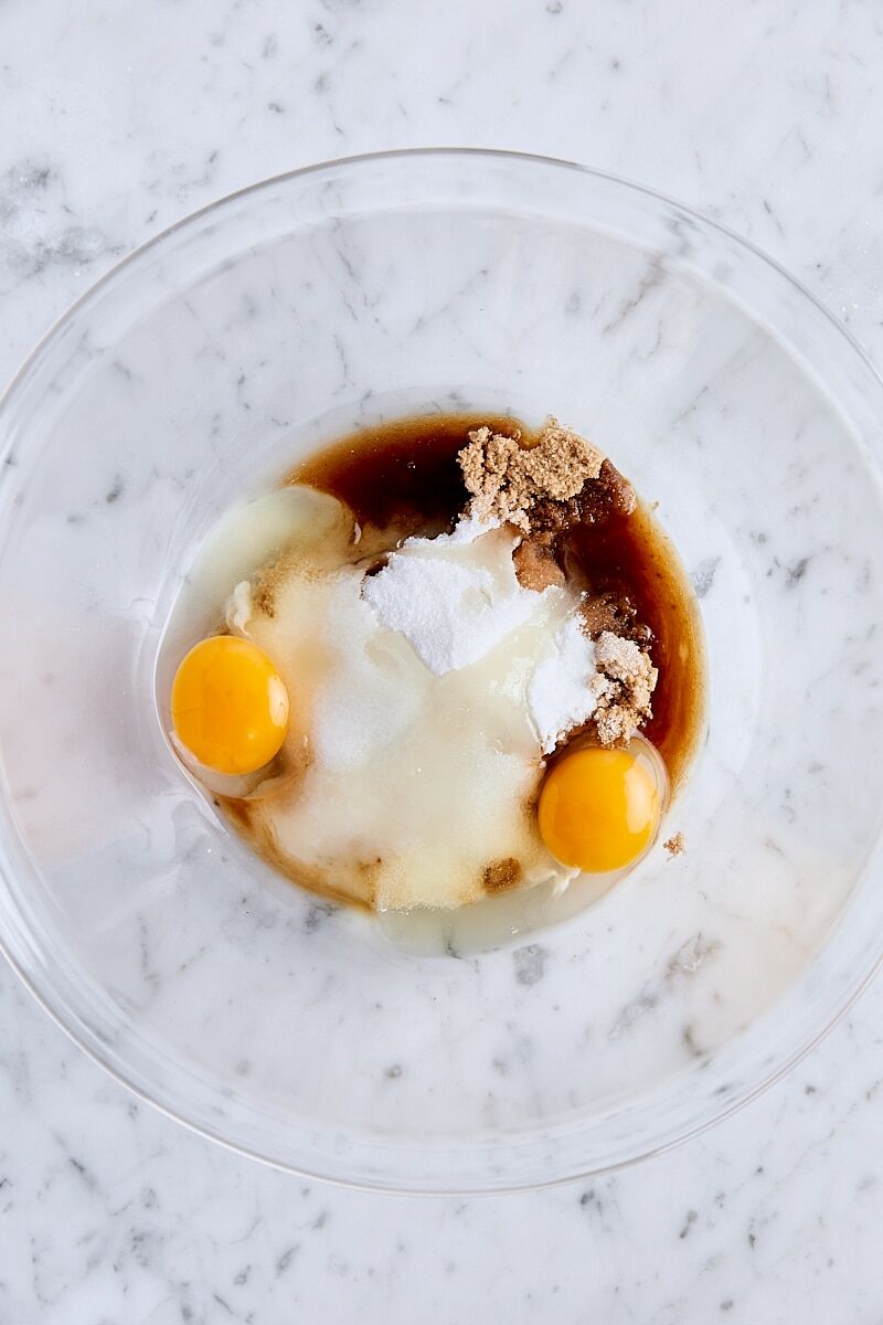 Eggs, sugar, light brown sugar, and vanilla extract in large mixing bowl