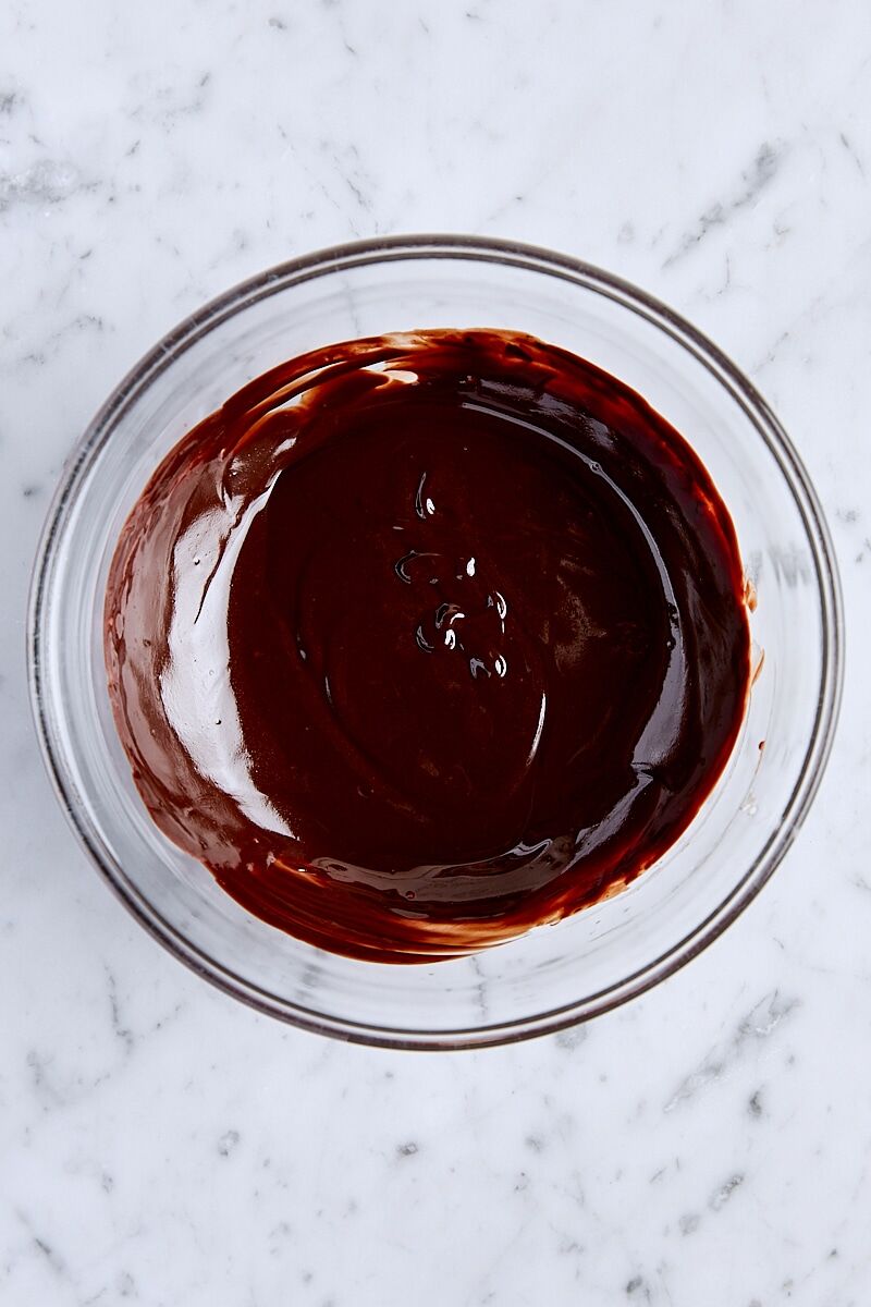 Butter and chocolate melted together in glass bowl