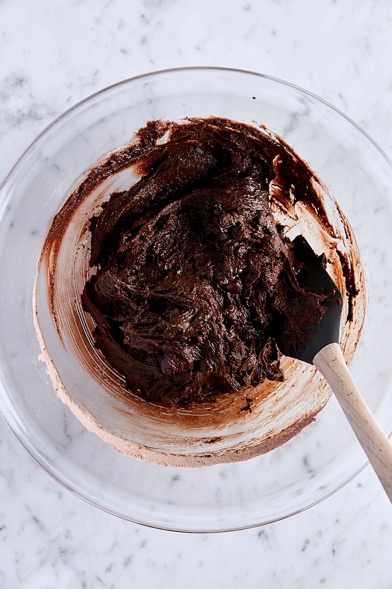 Mixed cookie dough in large bowl with spatula
