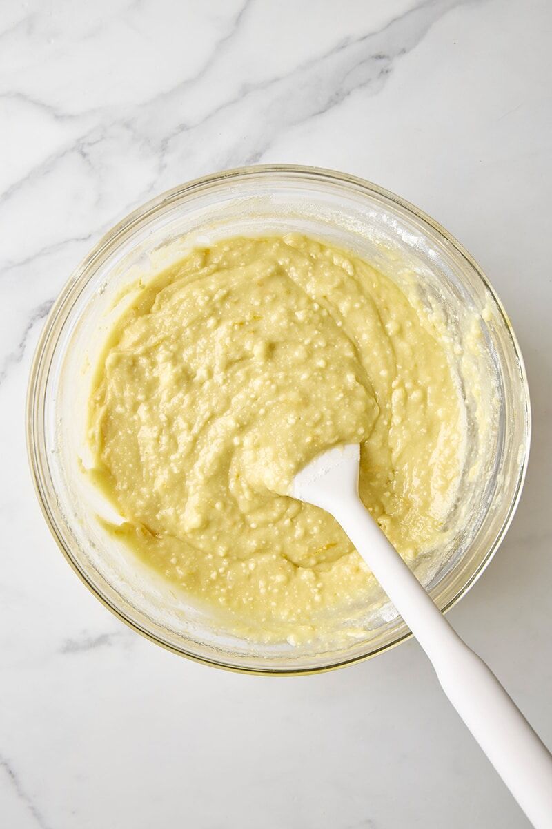 Mixed batter in glass bowl with spatula