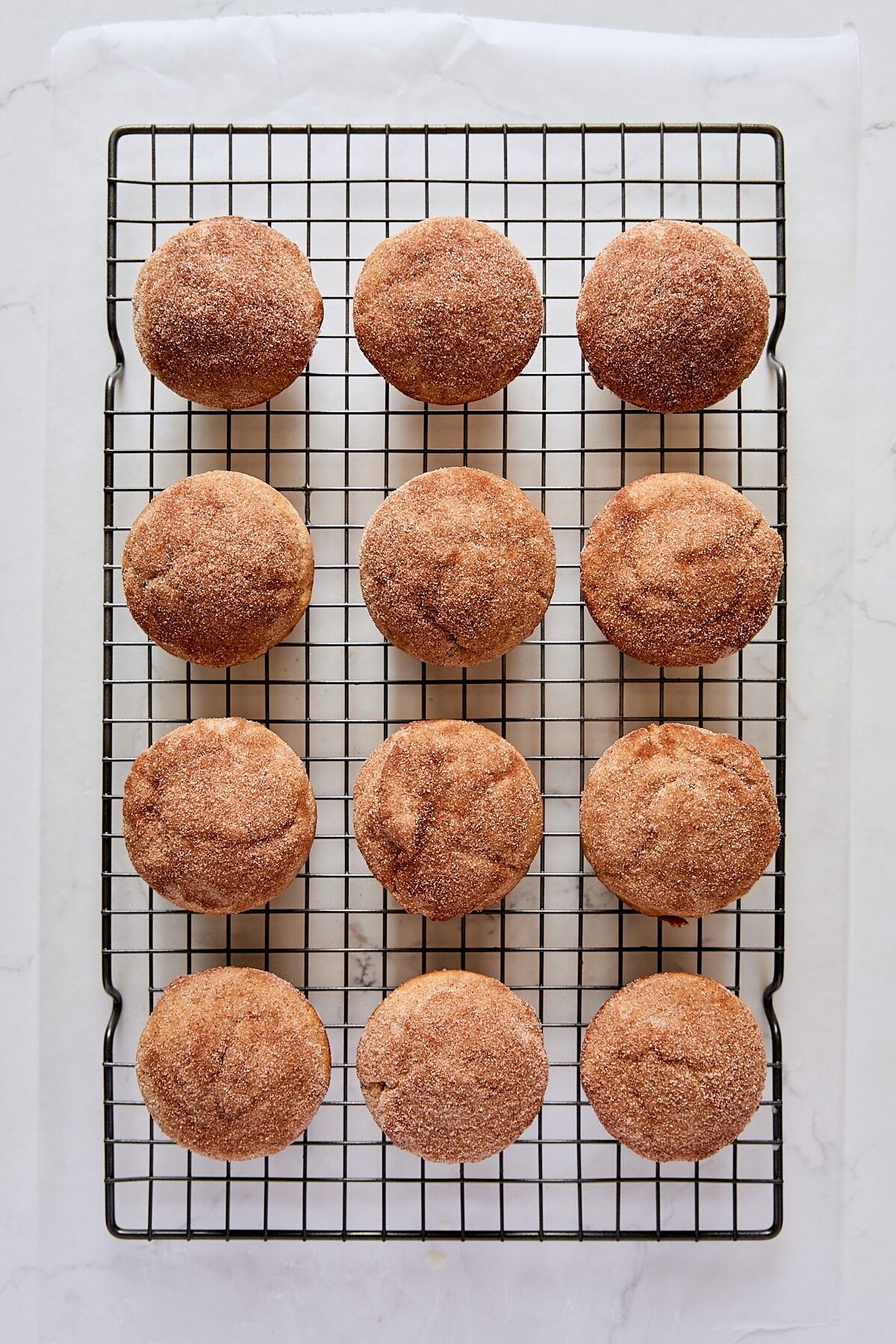 Cinnamon-sugar topped donut muffins on wire cooling rack