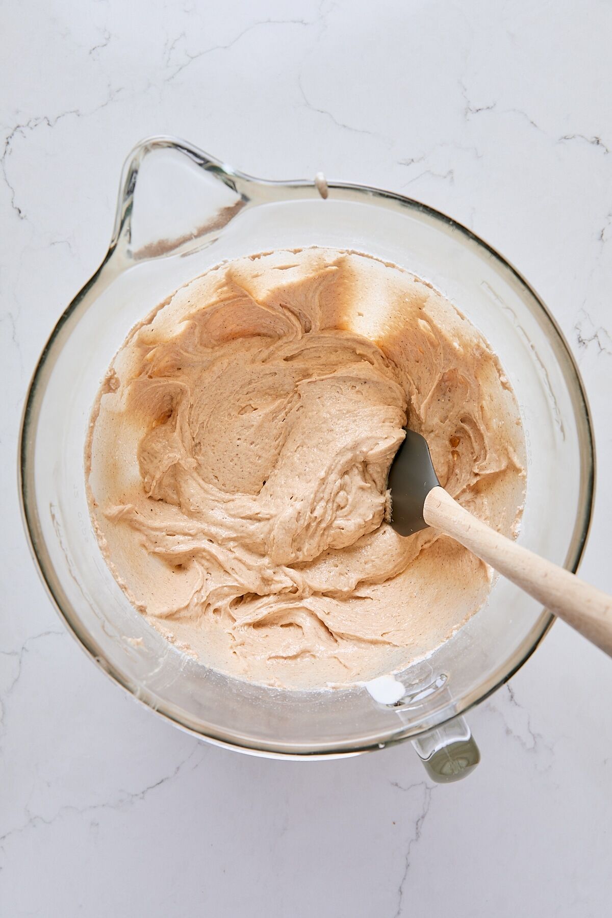 Donut muffin batter in glass mixer bowl with spatula