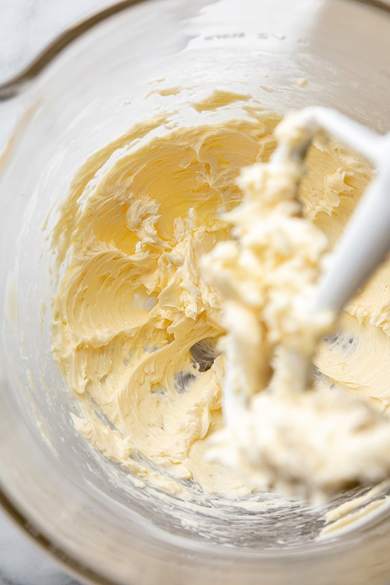 Softened butter and salt mixed together in glass mixing bowl