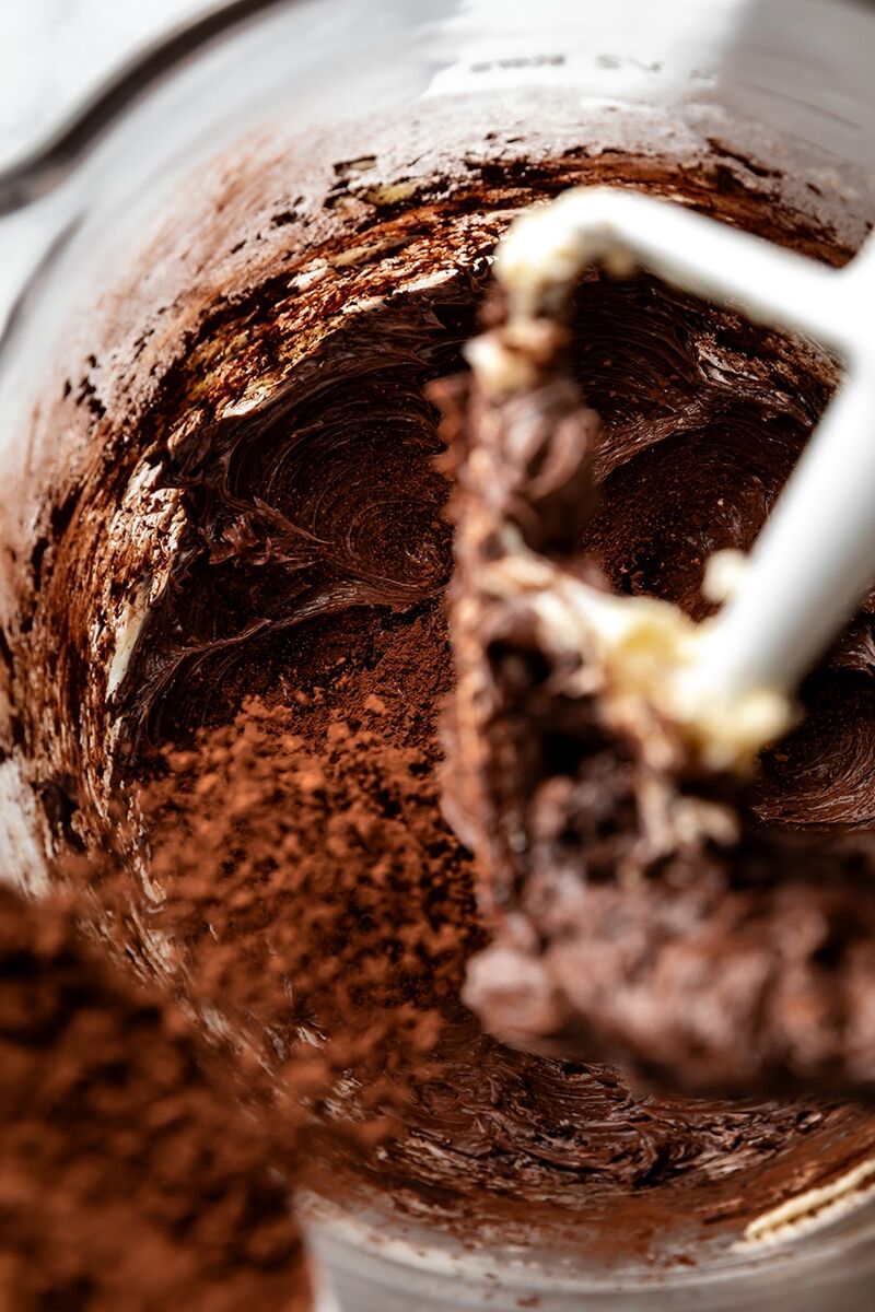 Sifted cocoa powder gradually added to butter mixture