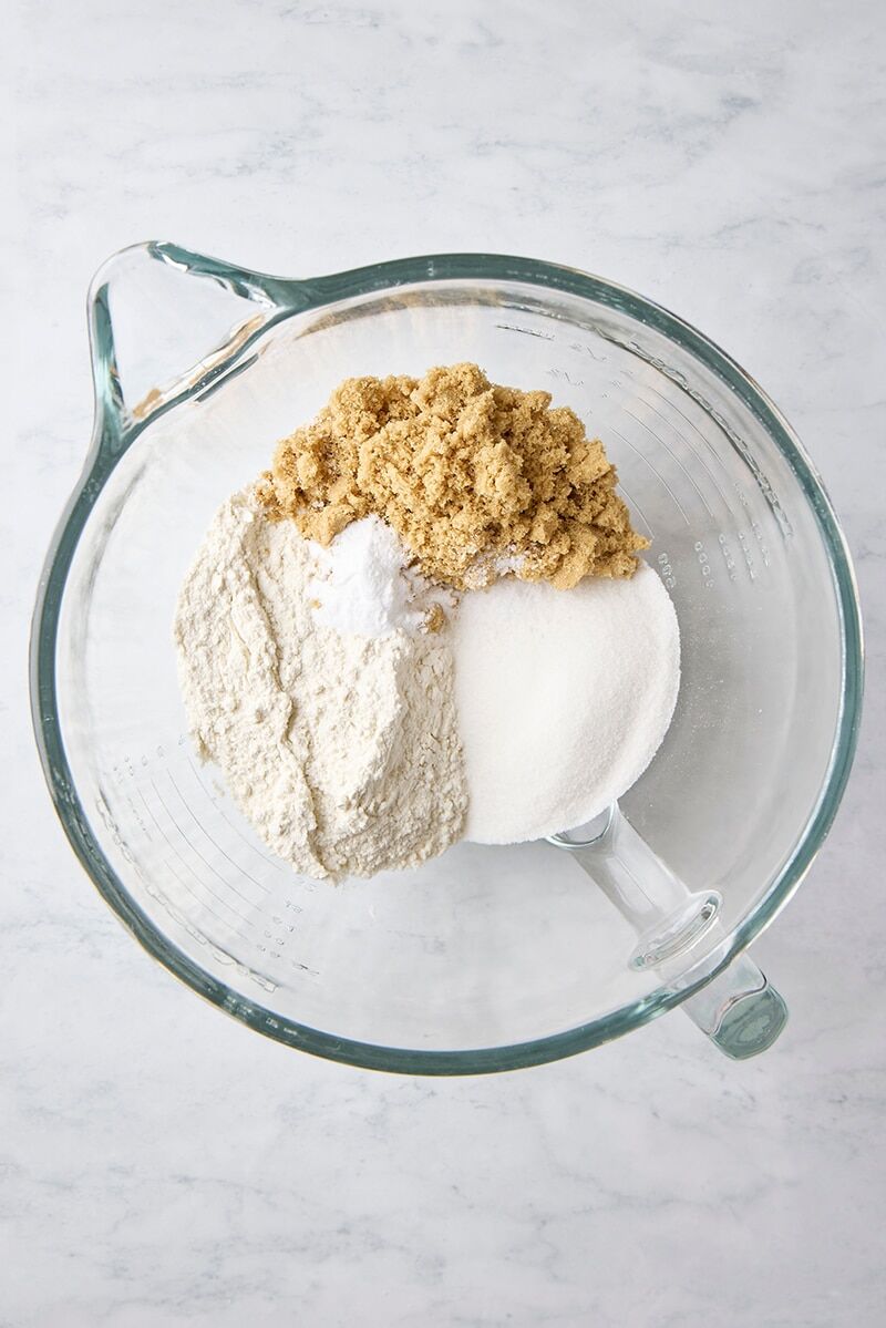 Flour, baking soda, salt, brown sugar, and granulated sugar in glass mixer bowl