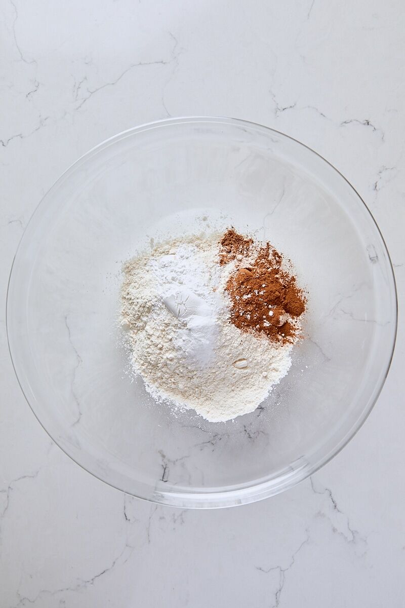 Flour, cinnamon, nutmeg, baking powder, baking soda, and salt in large glass bowl