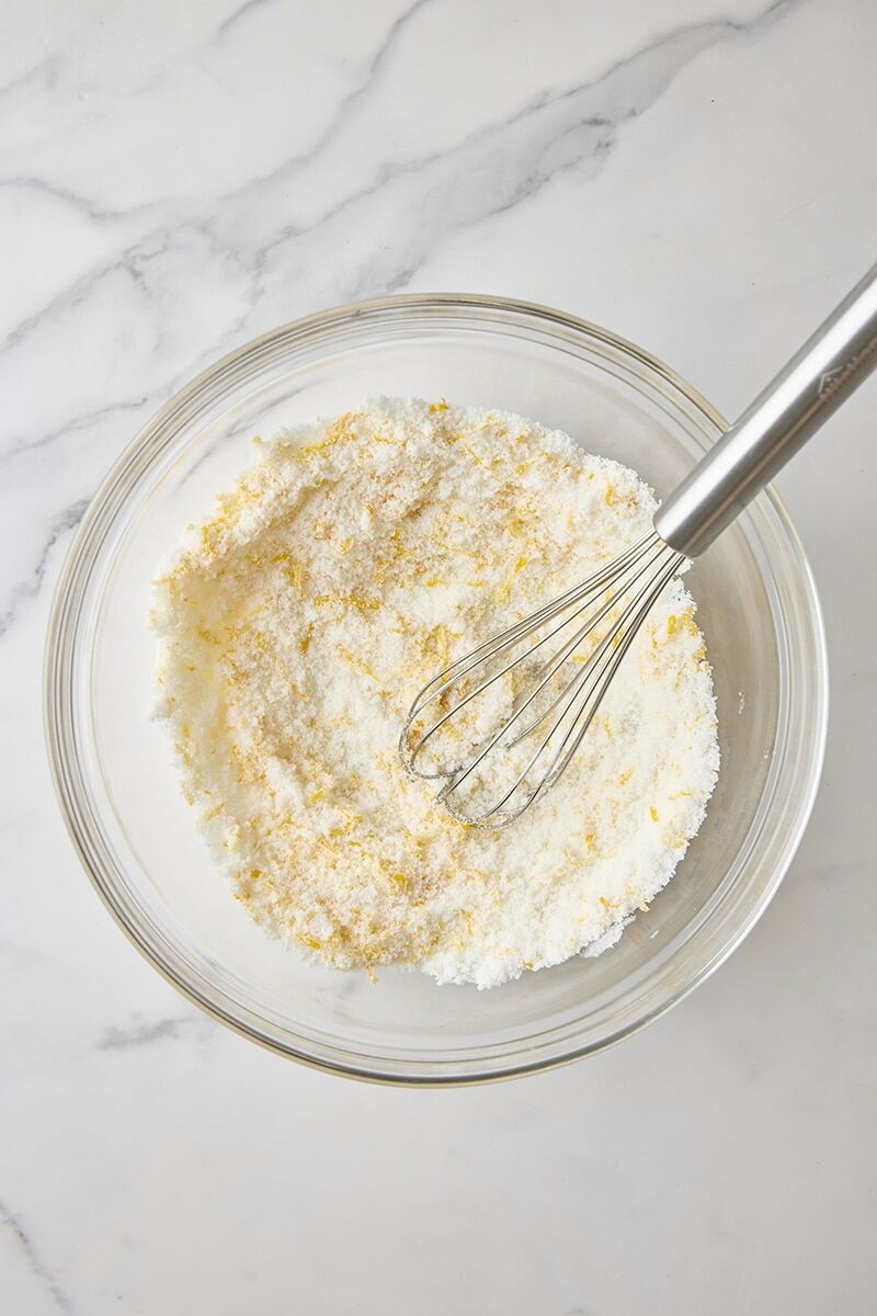 Lemon-sugar whisked together in glass bowl