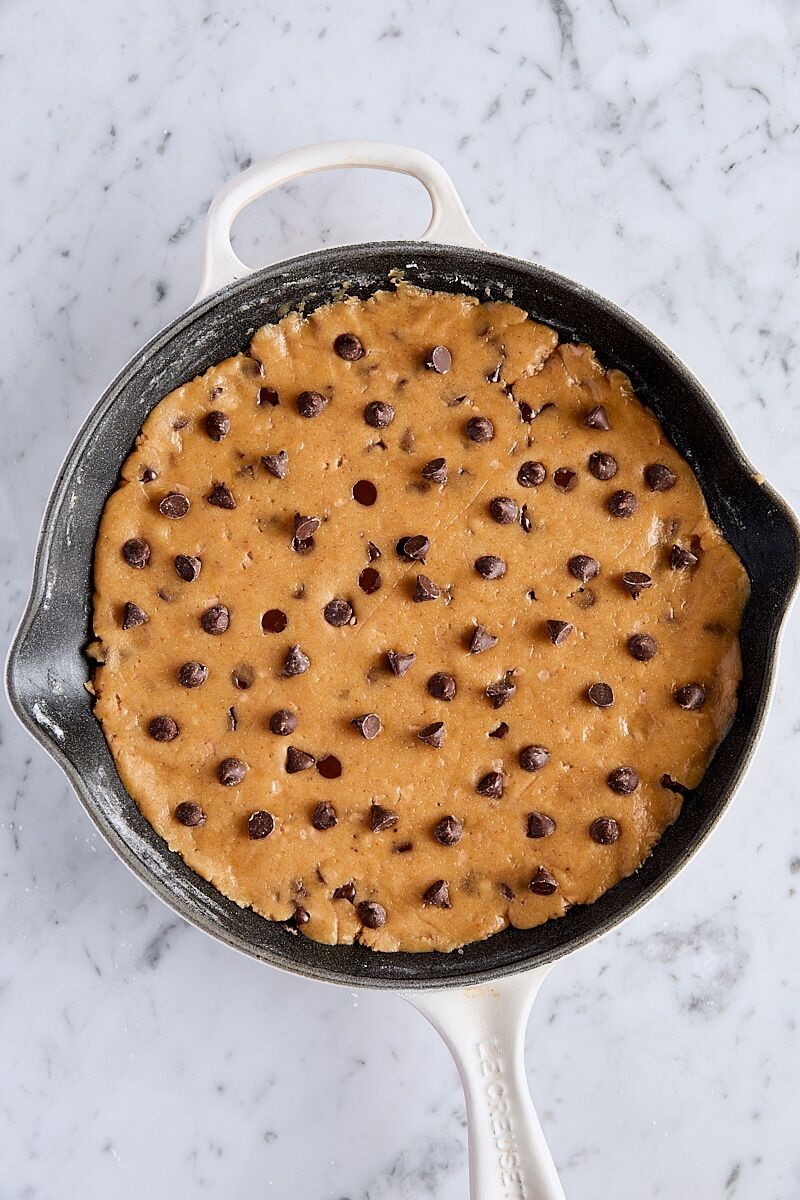 Cookie dough pressed into skillet and topped with chocolate chips