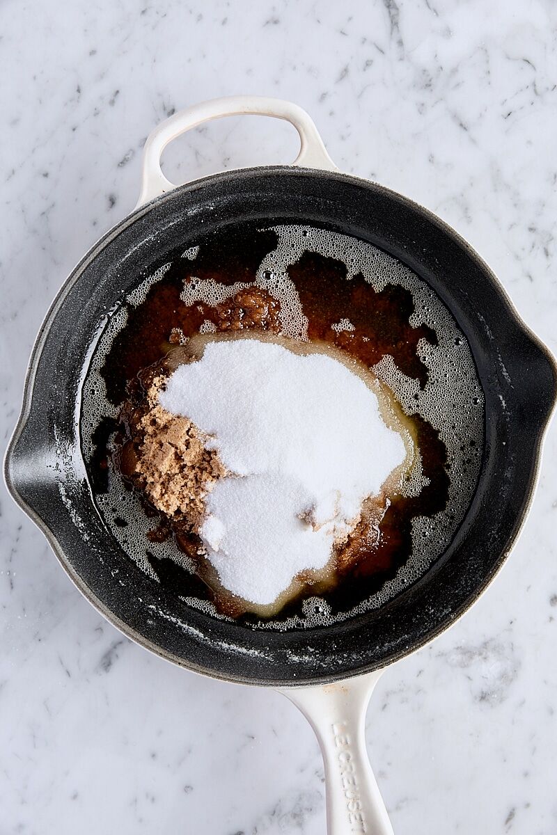 Granulated sugar, brown sugar, and melted brown butter in skillet