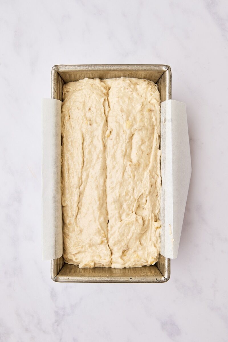 Banana bread batter in parchment-lined loaf pan