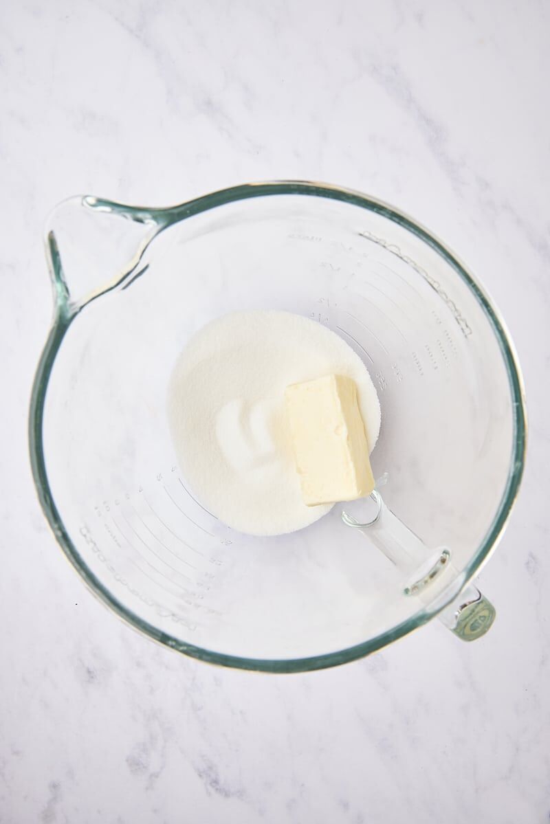 Butter and granulated sugar in glass mixer bowl