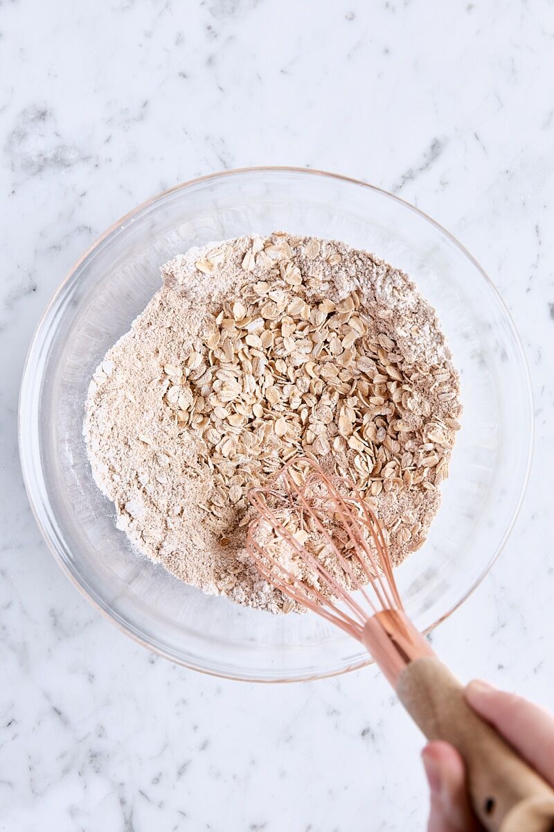 Oat topping ingredients whisked together in glass bowl