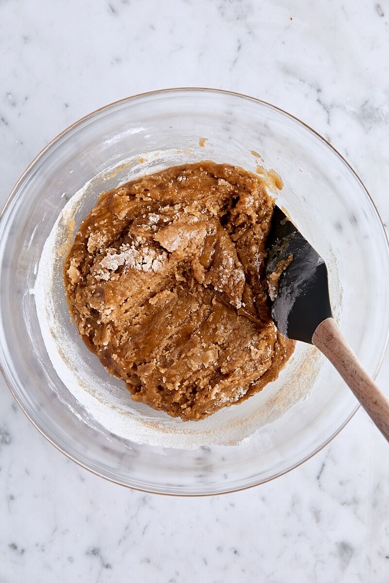 Blondie batter folded with spatula in glass bowl