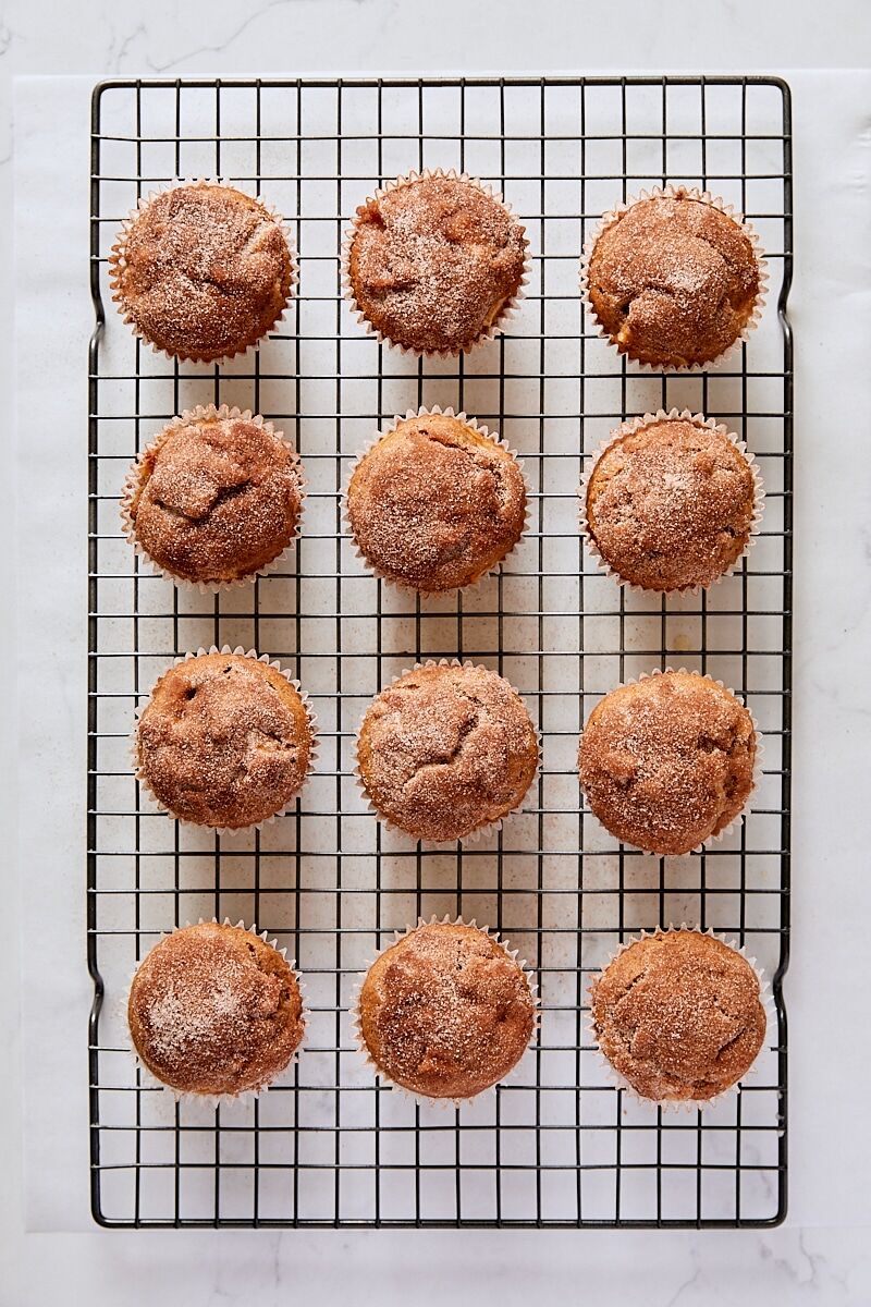Cinnamon-sugar topped muffins on wire cooling rack