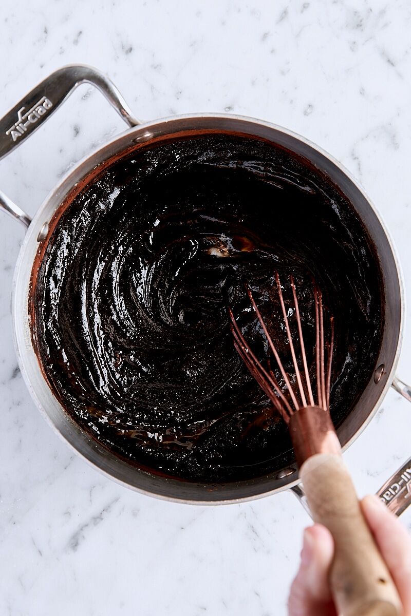 Egg, egg yolk, and vanilla extract whisked into brownie batter