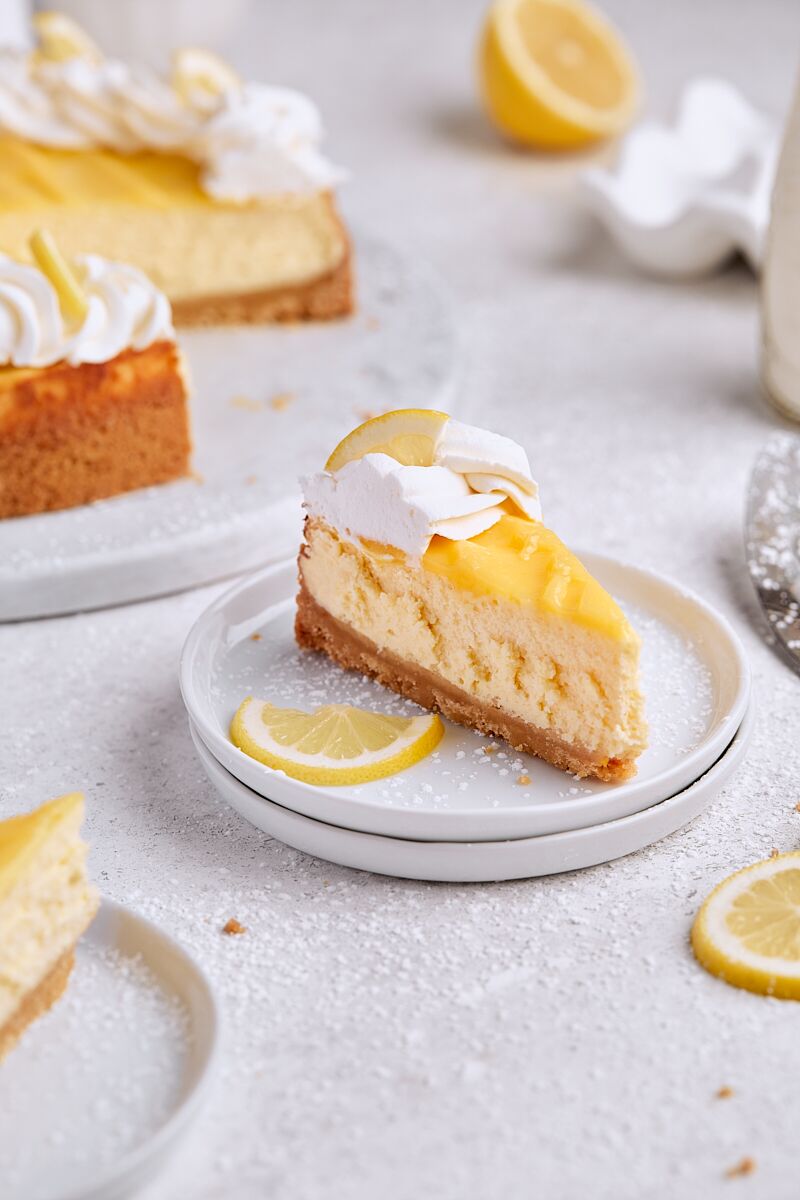 Slice of lemon curd cheesecake on white plate