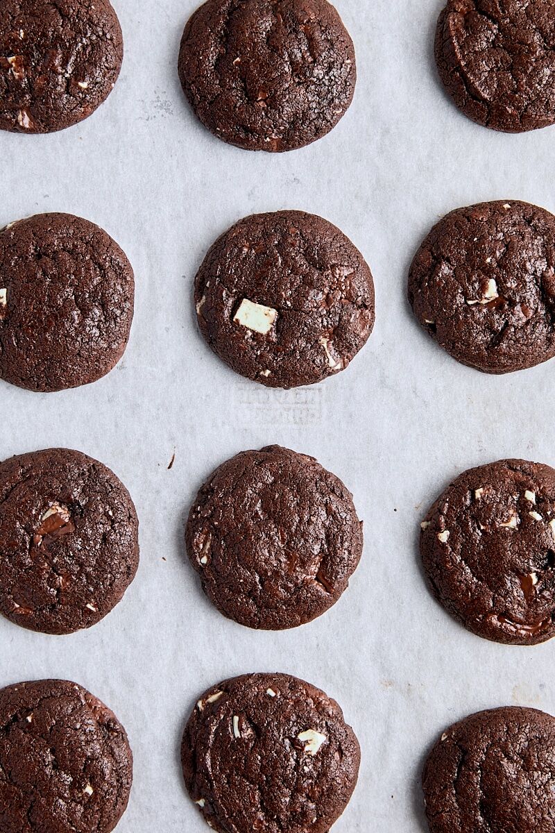 Baked chocolate mint cookies on parchment-lined baking sheet