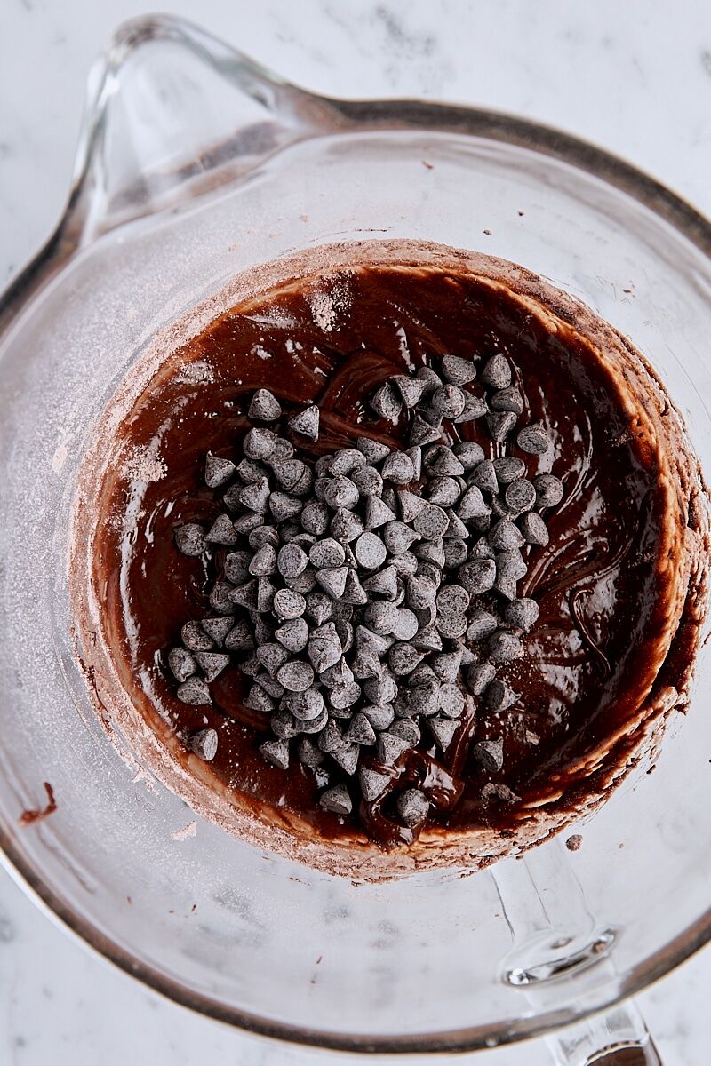 Brownie cookie dough with chocolate chips in glass mixing bowl