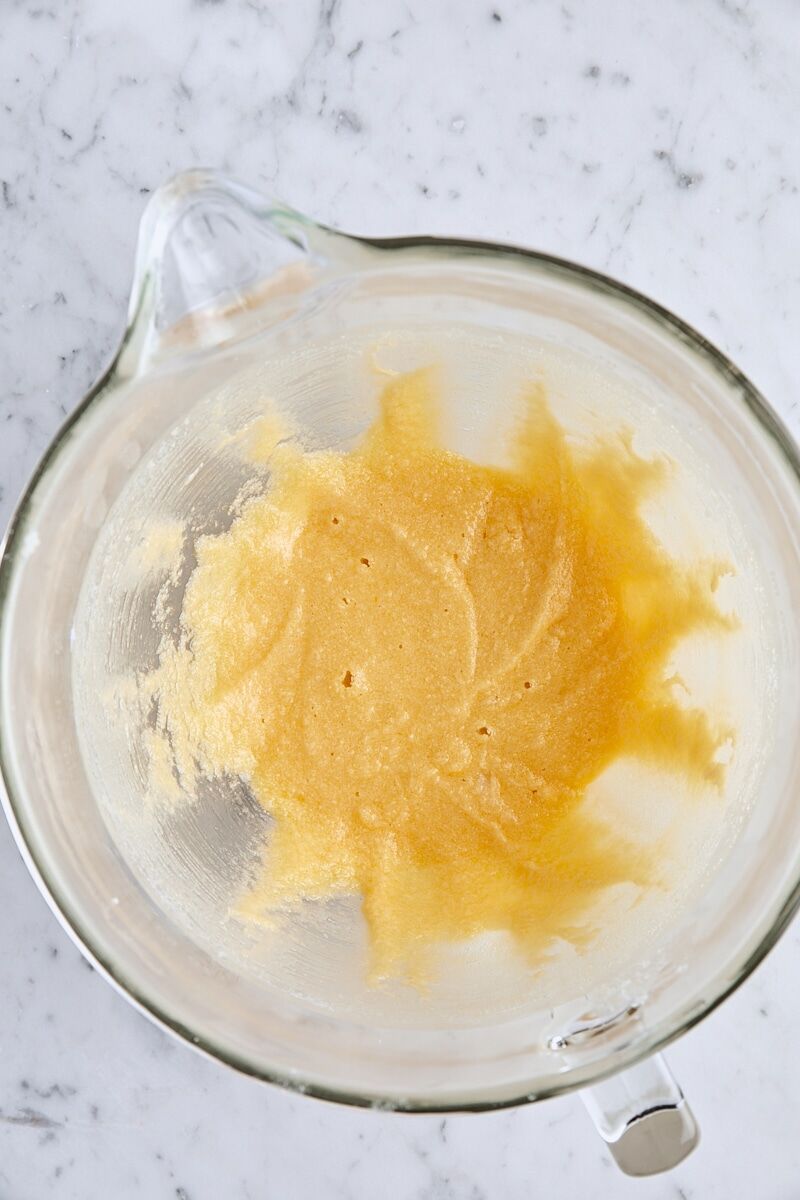 Egg mixed into batter in glass mixing bowl