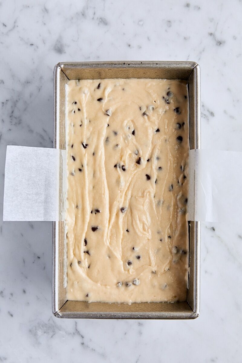Chocolate chip loaf cake batter in parchment-lined loaf pan