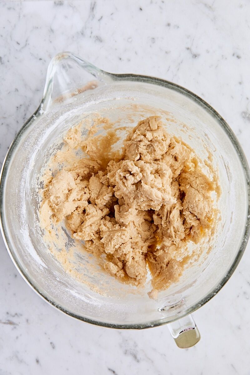Soft yeast roll dough in glass mixing bowl