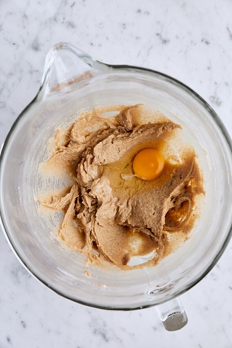 Egg added to batter in glass mixing bowl