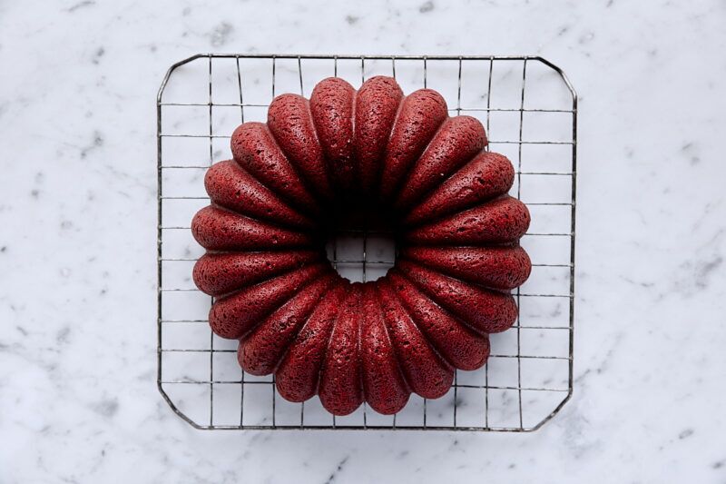 Baked red velvet bundt cake on wire cooling rack
