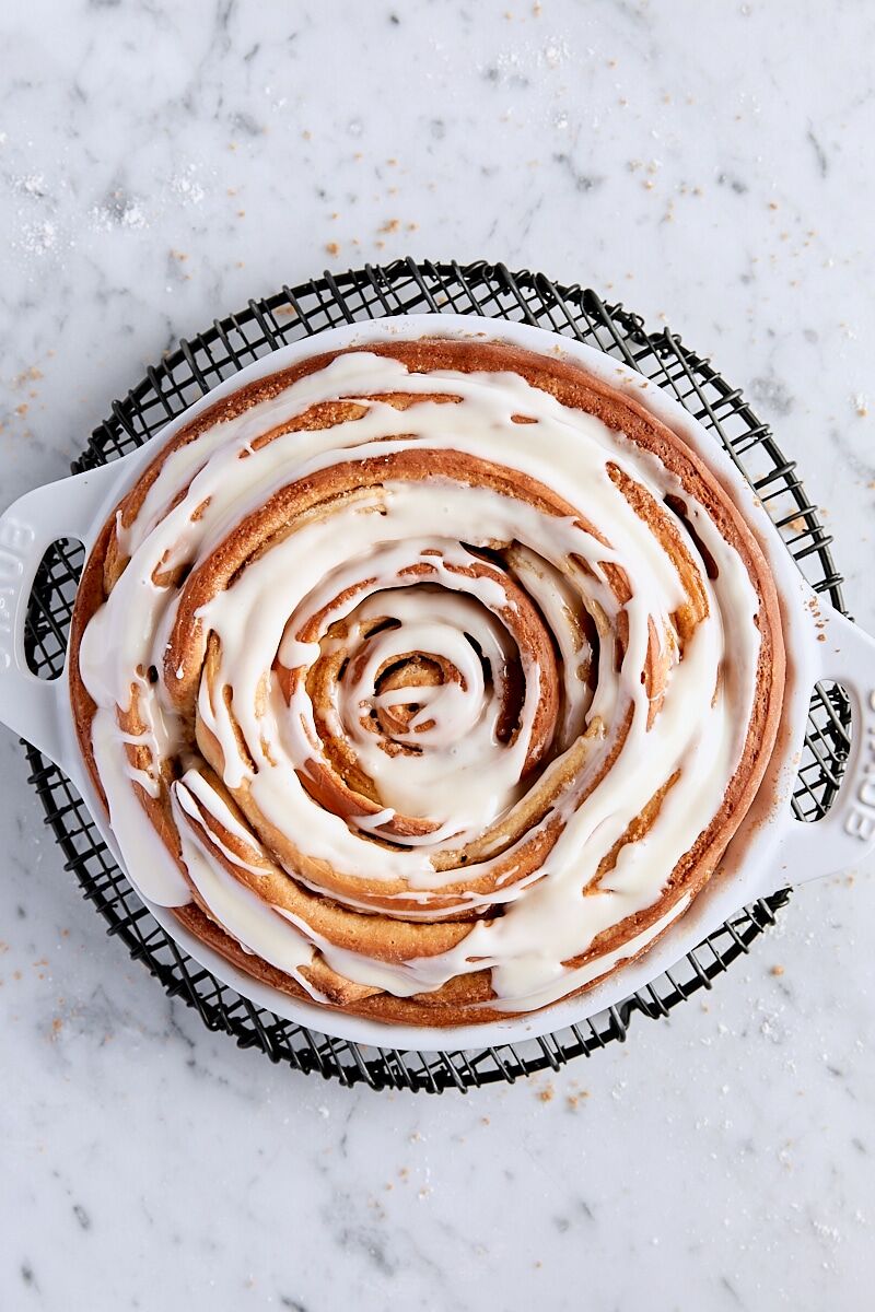 Baked giant cinnamon roll on wire cooling rack