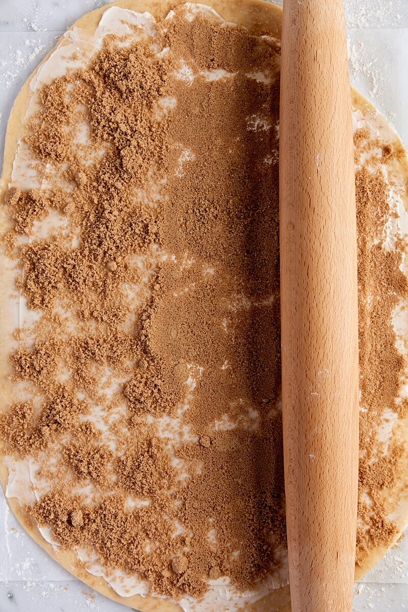 Brown sugar-cinnamon filling pressed into dough with rolling pin