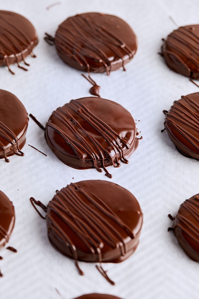 Chocolate-coated thin mint cookies on parchment lined baking sheet