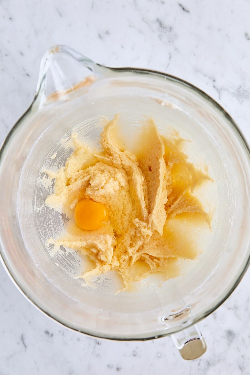 Egg added to batter in glass mixing bowl