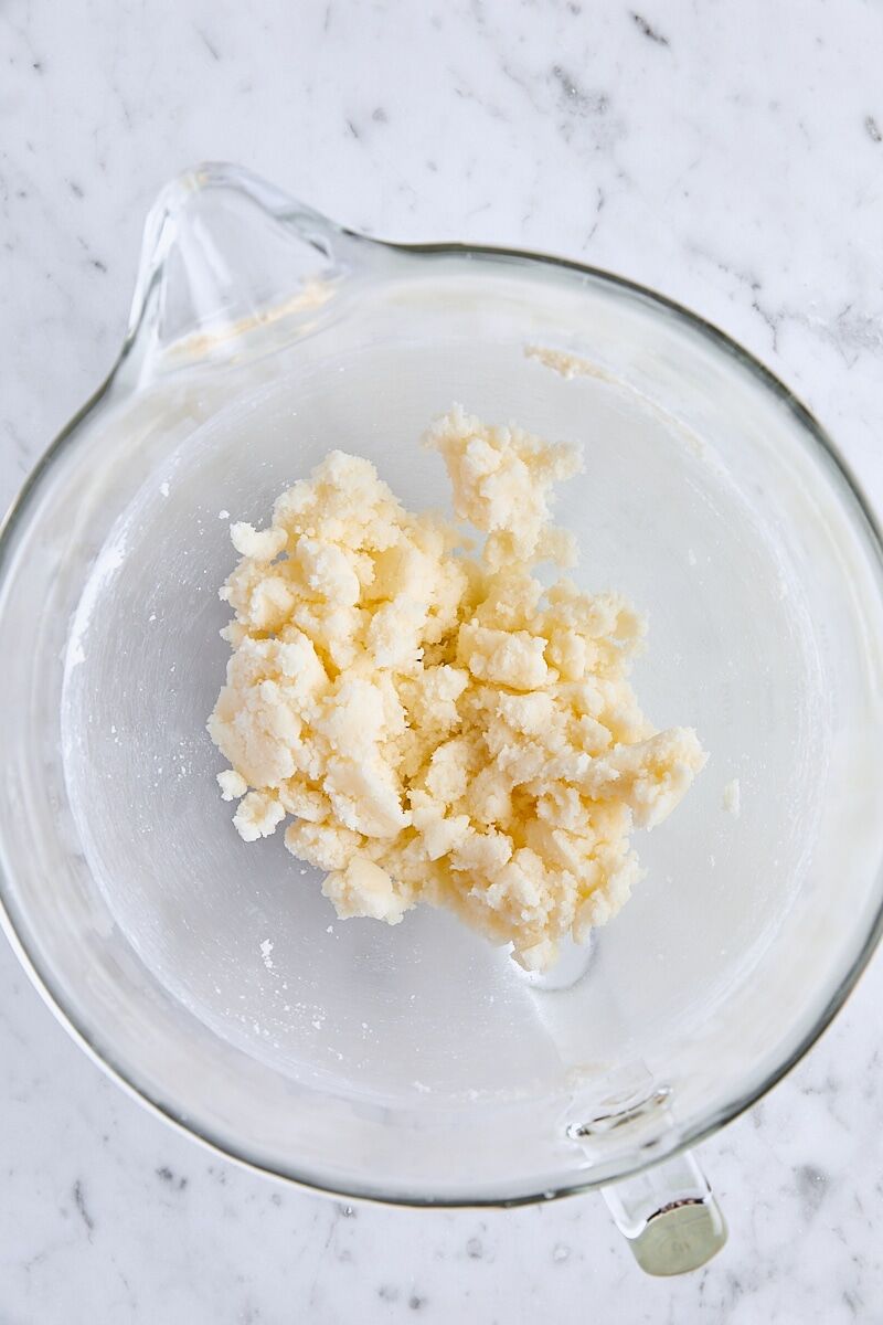Butter and granulated sugar mixed together in glass mixing bowl