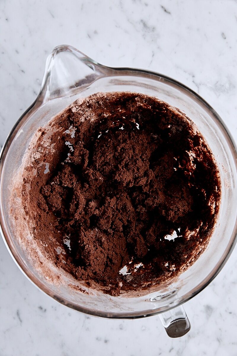 Mixed thin mint cookie dough in glass mixing bowl