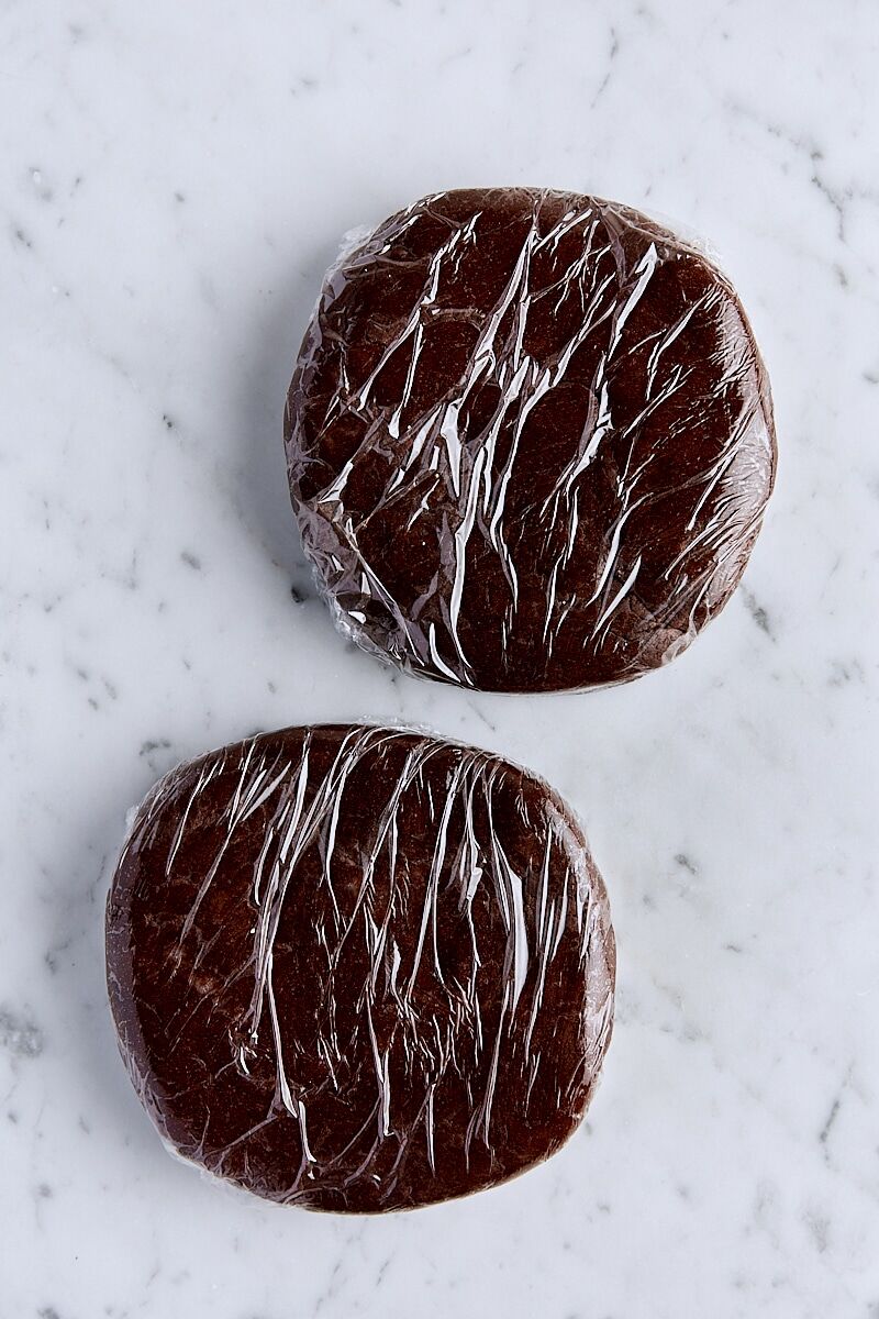 Thin mint cookie dough divided into two disks and wrapped in plastic wrap