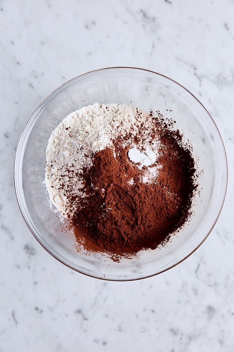 Flour, Dutch process cocoa, baking powder, and salt in glass bowl