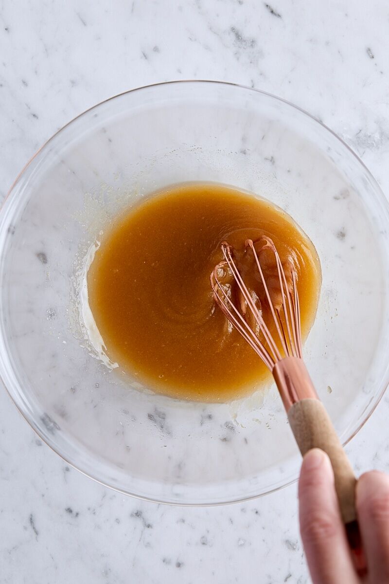 Melted butter, sugars, vanilla extract, and lemon zest combined in large glass bowl