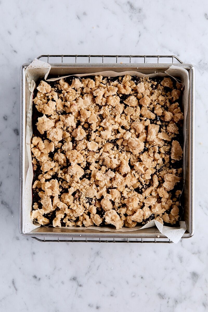 Crumb topping sprinkled over blackberry filling
