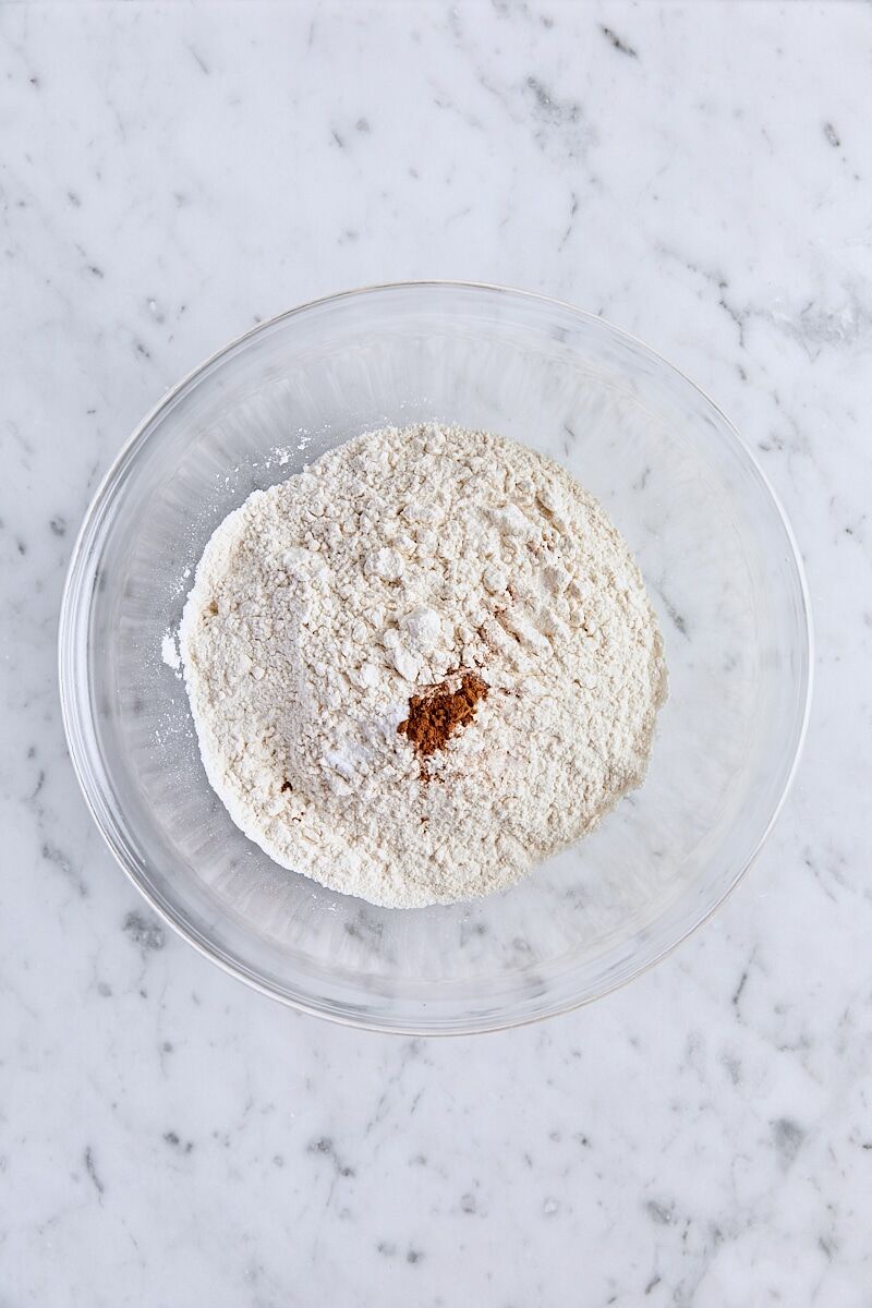 All-purpose flour, baking soda, salt, and cinnamon in glass bowl