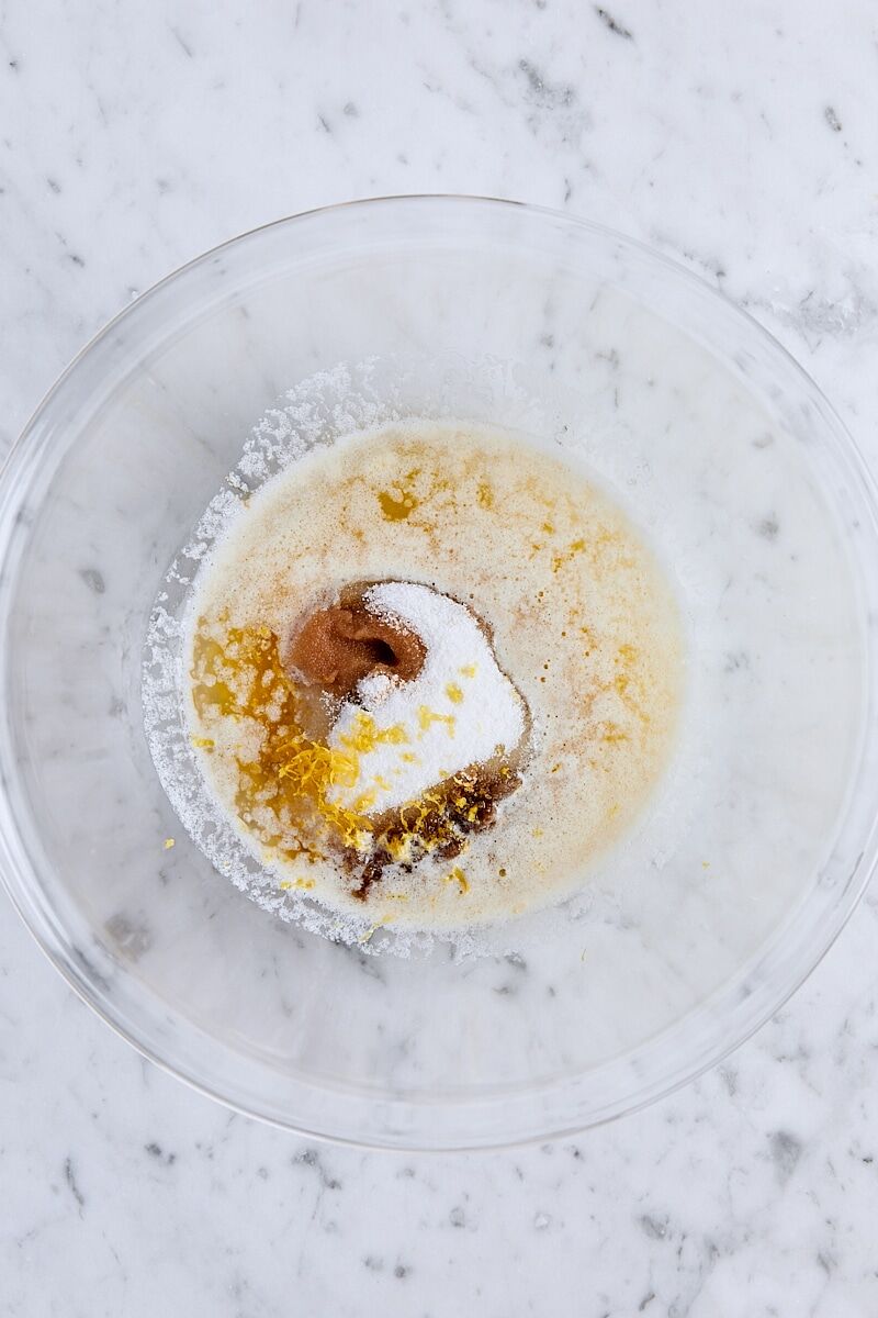 Melted butter, sugar, light brown sugar, vanilla extract, and lemon zest in large glass bowl