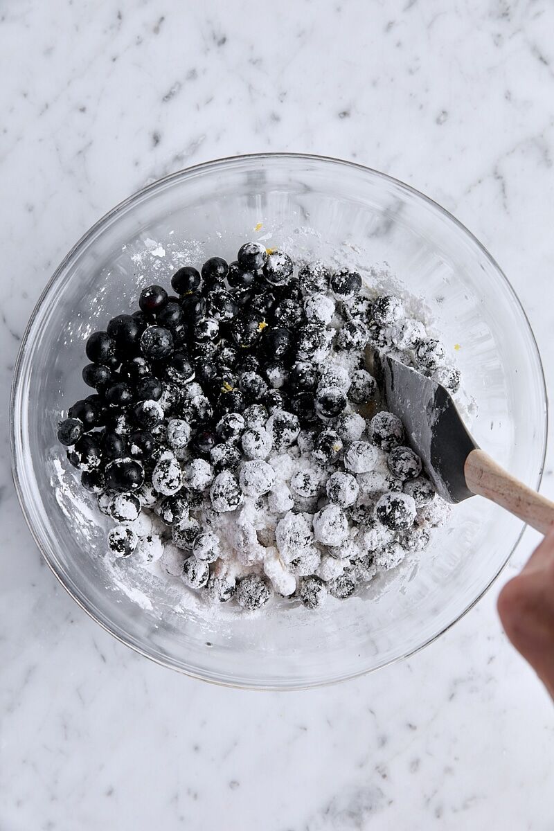 Blueberry filling mixed together in glass bowl with spatula