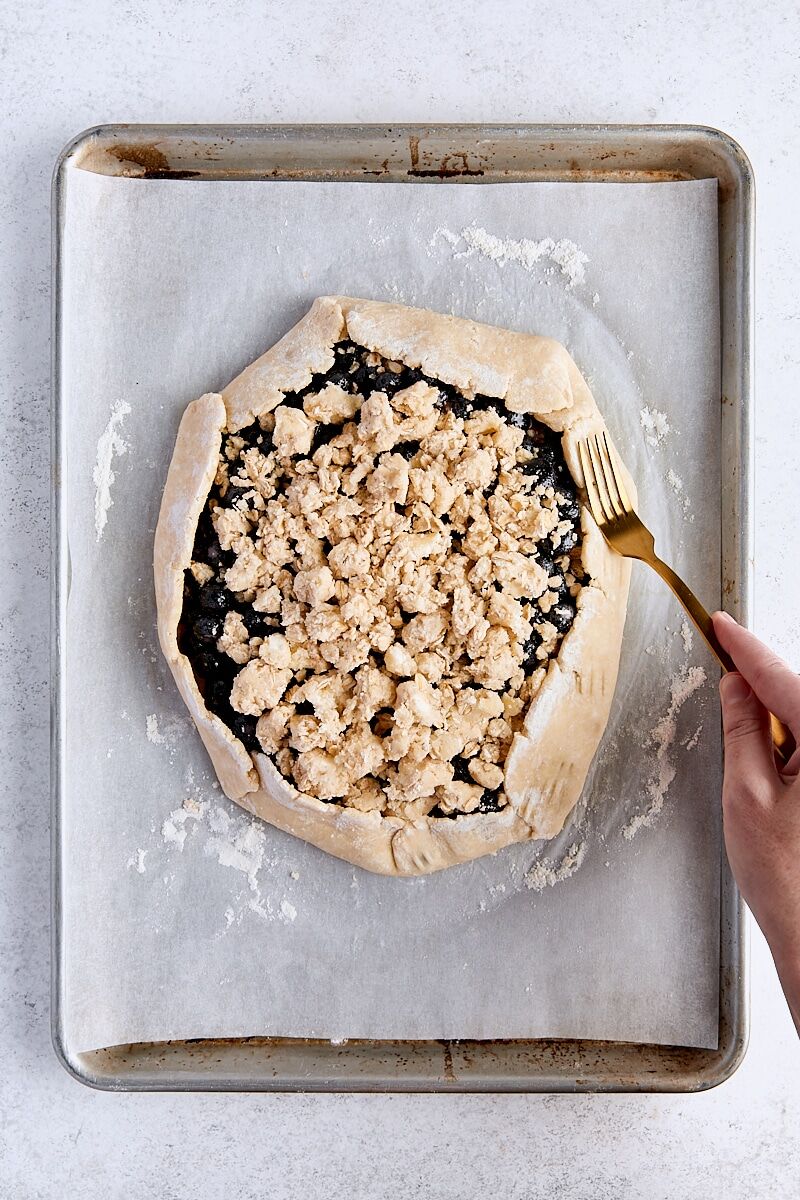 Galette dough edges pressed with fork to seal